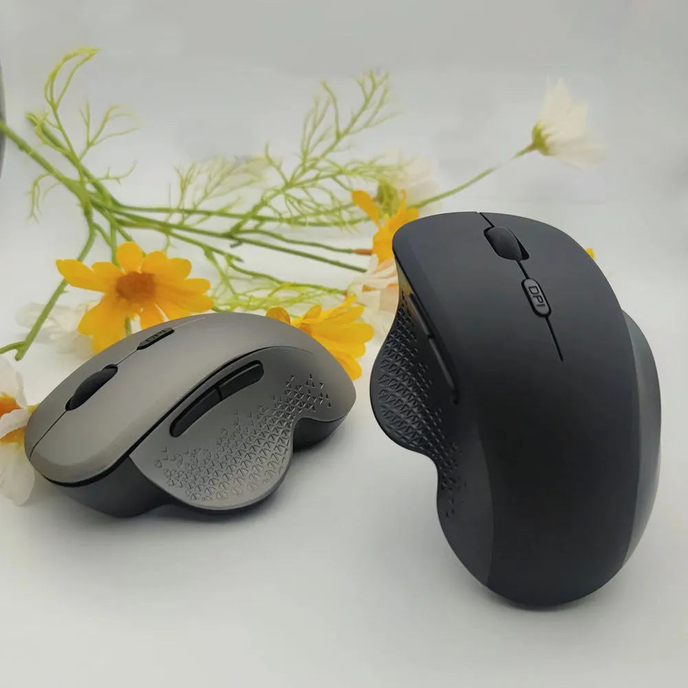 Grey and black wireless laptop mouse with USB charging cable on white background