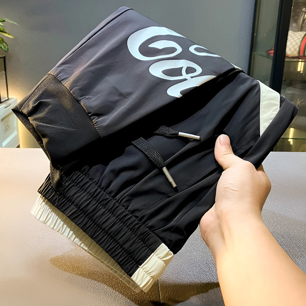 Men's black ankle band trousers with cropped casual fit in lightweight ice silk cotton fabric