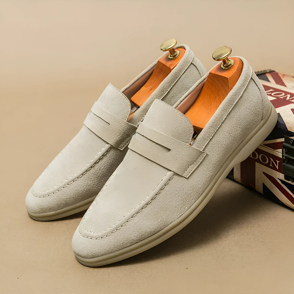 Men's black leather slip-on casual shoes with a round toe and rubber sole on a white background.