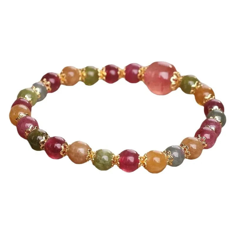 Close-up of a beaded bracelet with round strawberry quartz and tourmaline stones, 10mm in size.