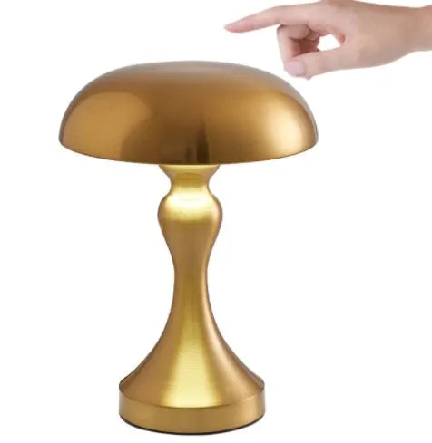 Metallic bronze touch-control LED desk lamp showing tri-colour light settings on a wooden desk.