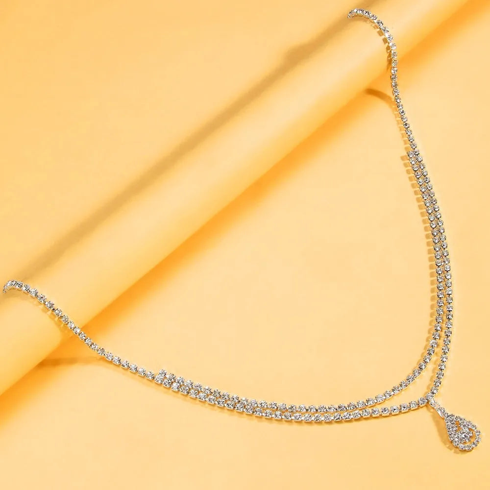 Gold and silver waist chain jewellery with a water drop pendant and adjustable lobster buckle clasp.