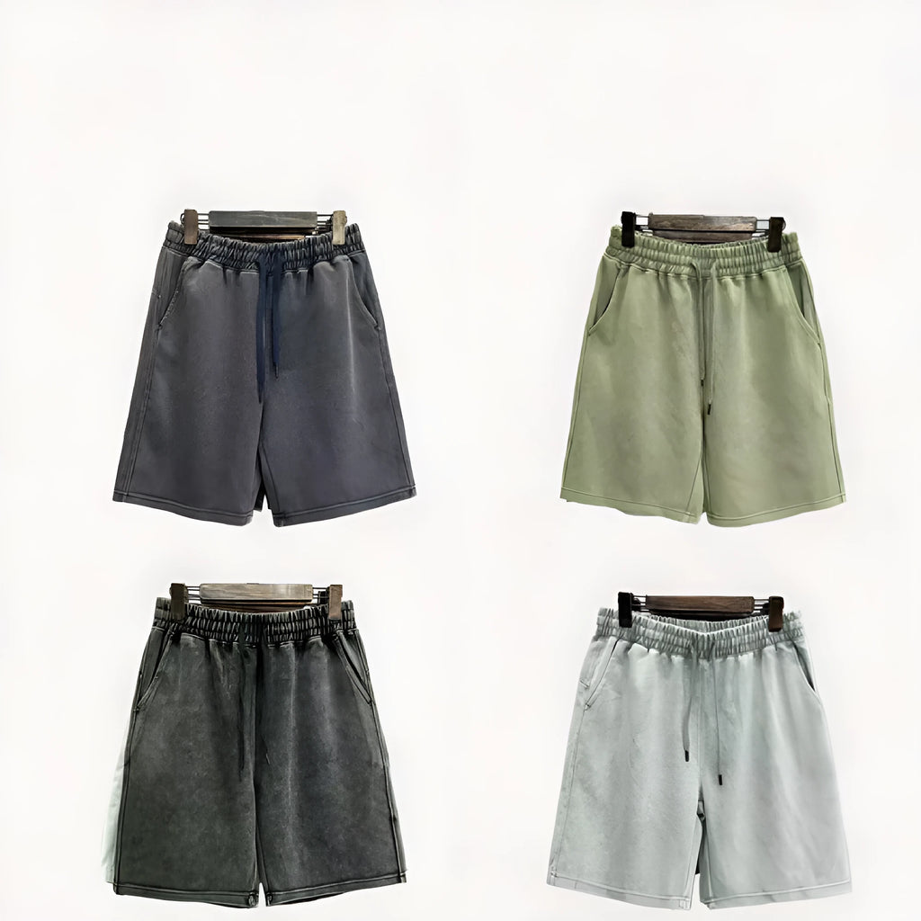 Man wearing loose-fit distressed cotton shorts in a solid colour.
