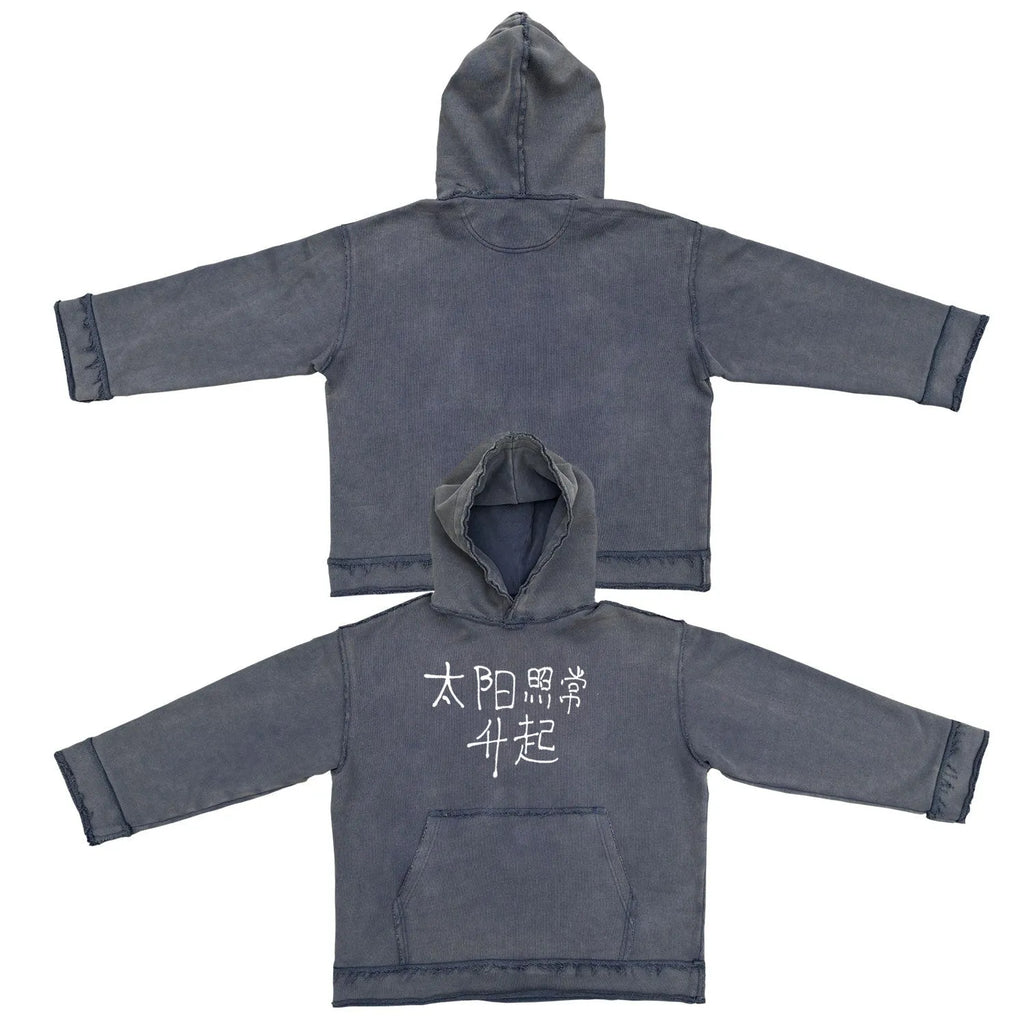Reverse dark blue hoodie sweater on a model, showing knitted texture and hood.
