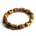 Natural yellow tigereye gemstone bracelet with ethnic constellation design on a wrist.