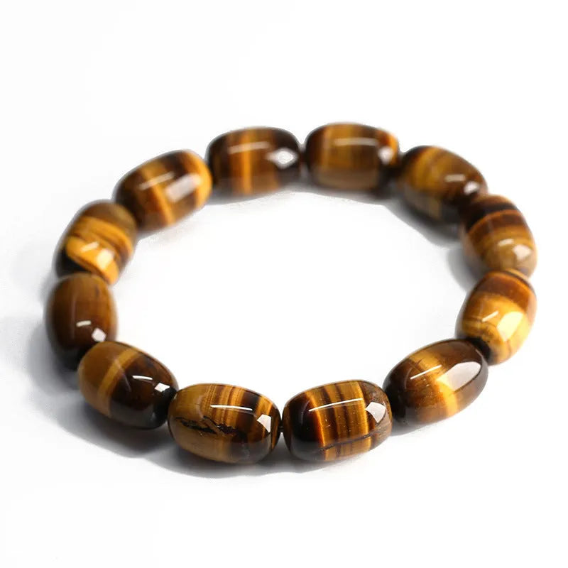 Natural yellow tigereye gemstone bracelet with ethnic constellation design on a wrist.