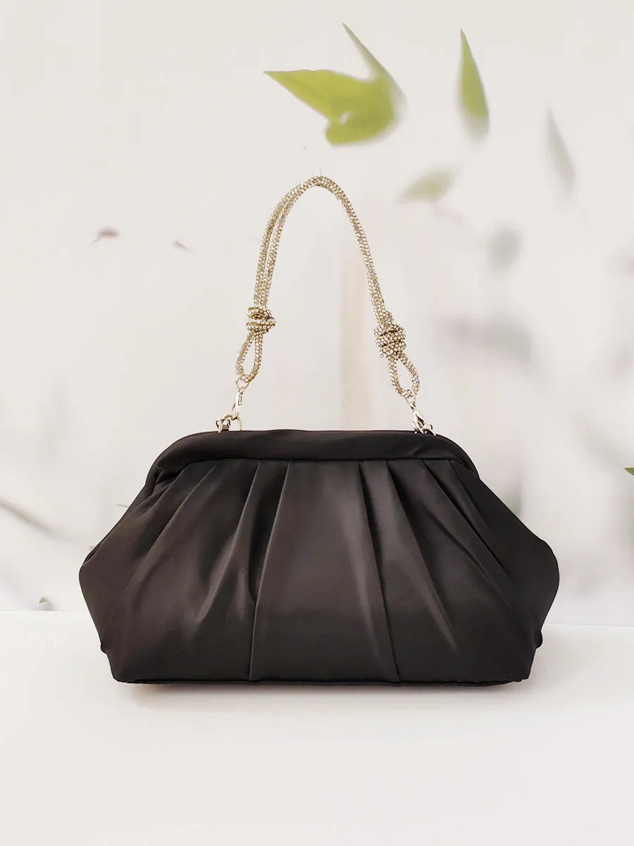 Soft shell-shaped lavender purple women's shoulder bag with fold, diamond, and chain details.
