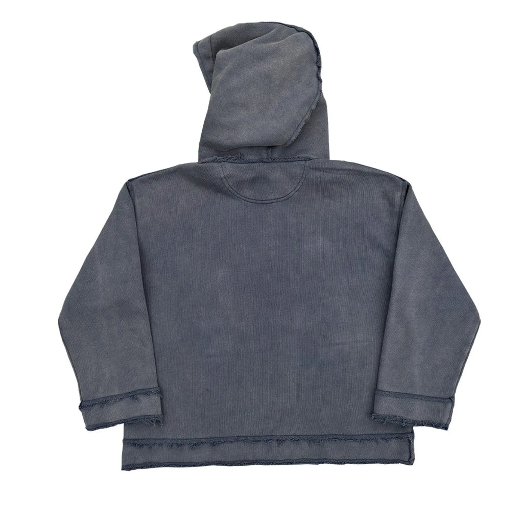 Reverse dark blue hoodie sweater on a model, showing knitted texture and hood.