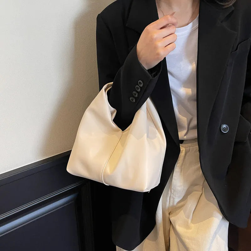 PU women's casual handbag in dumpling shape with sandwich pocket, shown in multiple colours.