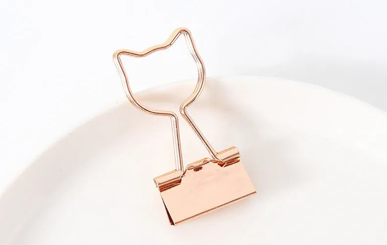 Gold long tail metal clip with a decorative flamingo, love, clouds, cat, cactus, or bow design top.
