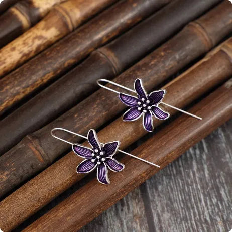 A pair of purple retro flower-shaped alloy earrings with an electroplated finish.
