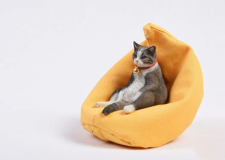 Lazy cat car ornament figure on fabric sofa, 7.5cm high resin model decoration.