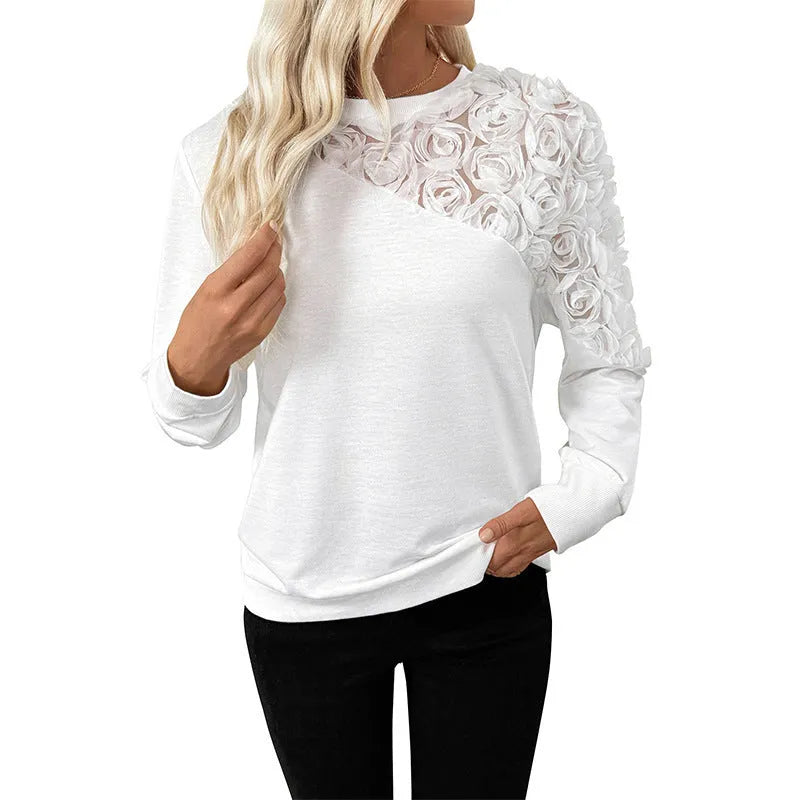 White women's long sleeve pullover top with a loose fit and floral pattern.