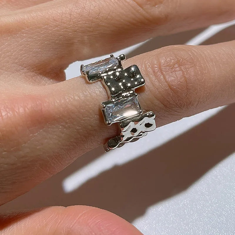 Silver geometric open ring with three-dimensional decoration and cross zircon design