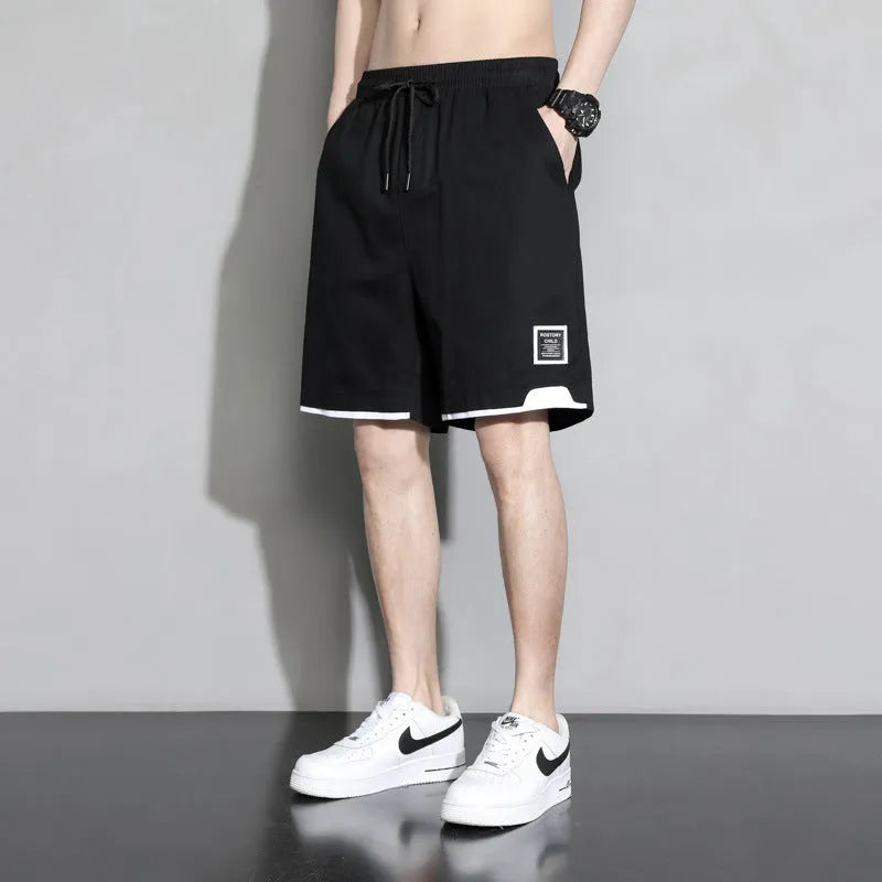 Boys' cotton shorts in black, khaki, or white, showing mid-waist and shorts length design.