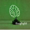 Minimalist green light bamboo desk lamp with USB plug on a wooden table.