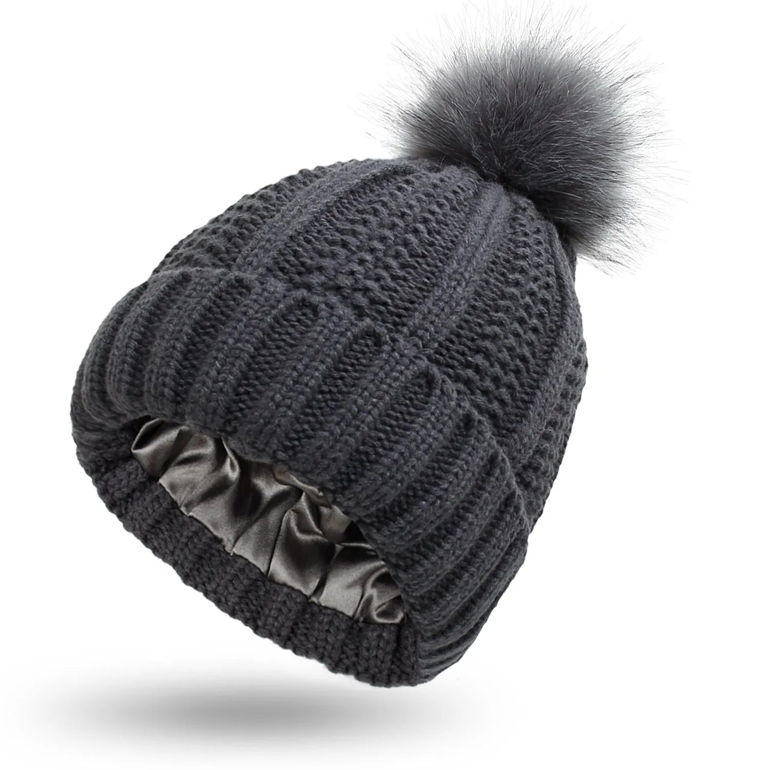 Women's knitted beanie hat with faux fur pom pom and satin lining in multiple colour options.