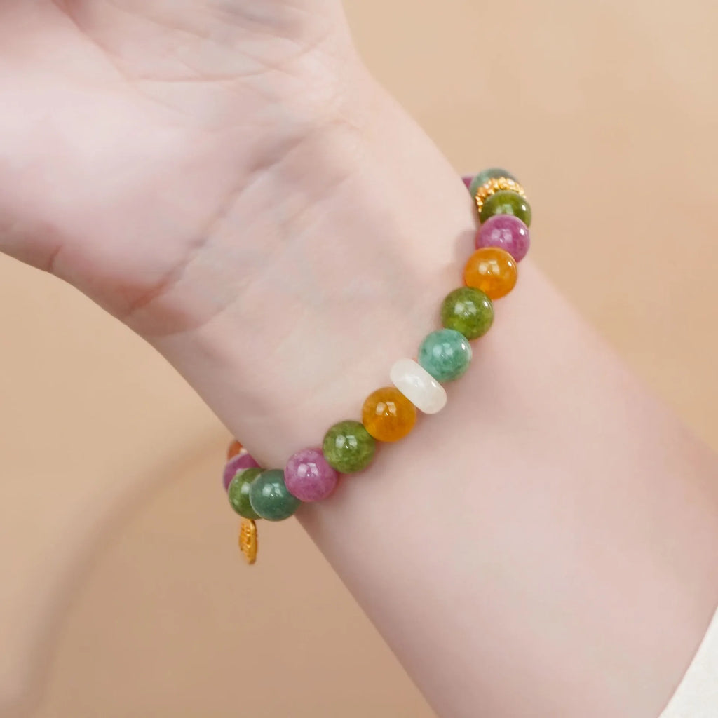Women's rainbow tourmaline half bracelet with electroplated finish showing natural stone colour variations