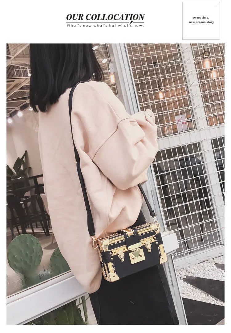 Women's black structured PU leather flap shoulder bag with cross-body strap and rivet details.