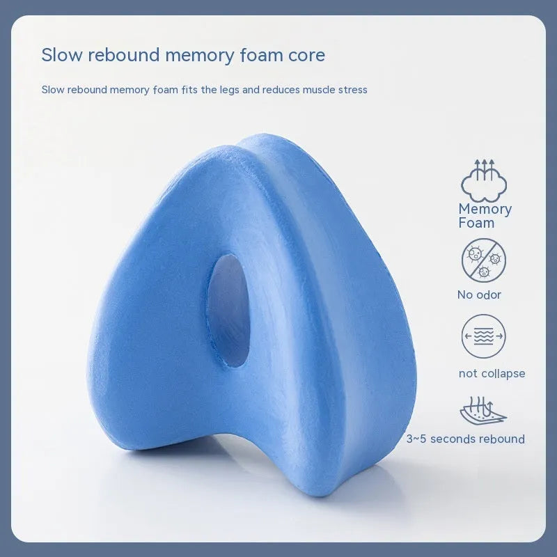Heart-shaped dark blue memory foam leg pillow for adult use.