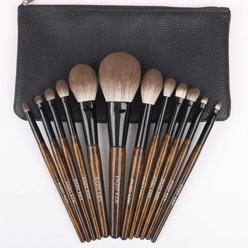 12-piece makeup brush set with wooden handles in a grey PU zip case
