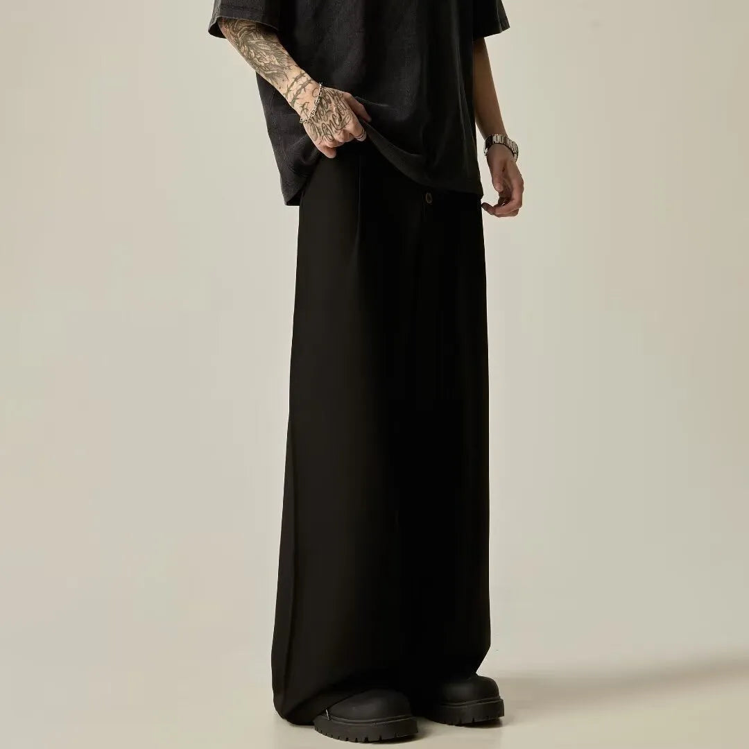 Men's solid black wide-leg casual trousers with a vertical tube cut and button fly.
