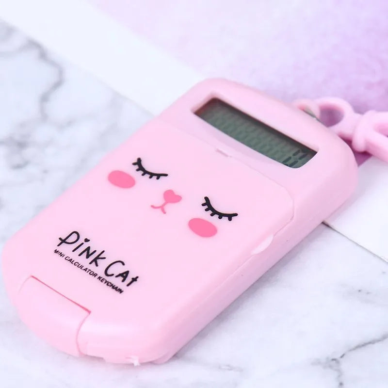Cookie-shaped mini plastic calculator with key ring, 6.4cm x 3.6cm x 11.2cm, in pink, blue, grey, or black