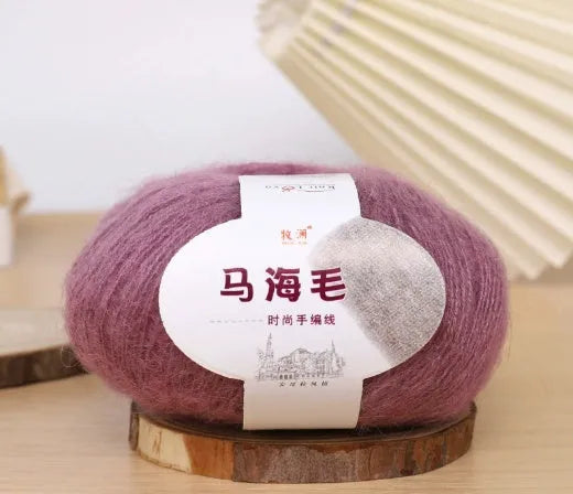 Ball of mohair yarn for DIY scarf knitting in one of 34 colours, including white, pink, blue, and green.