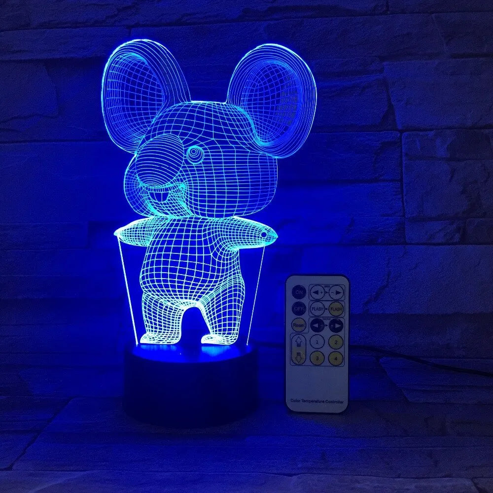 Black koala-shaped LED night light with remote control on a table.