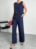 Red women's sleeveless top and wide leg trousers two-piece co-ord set.