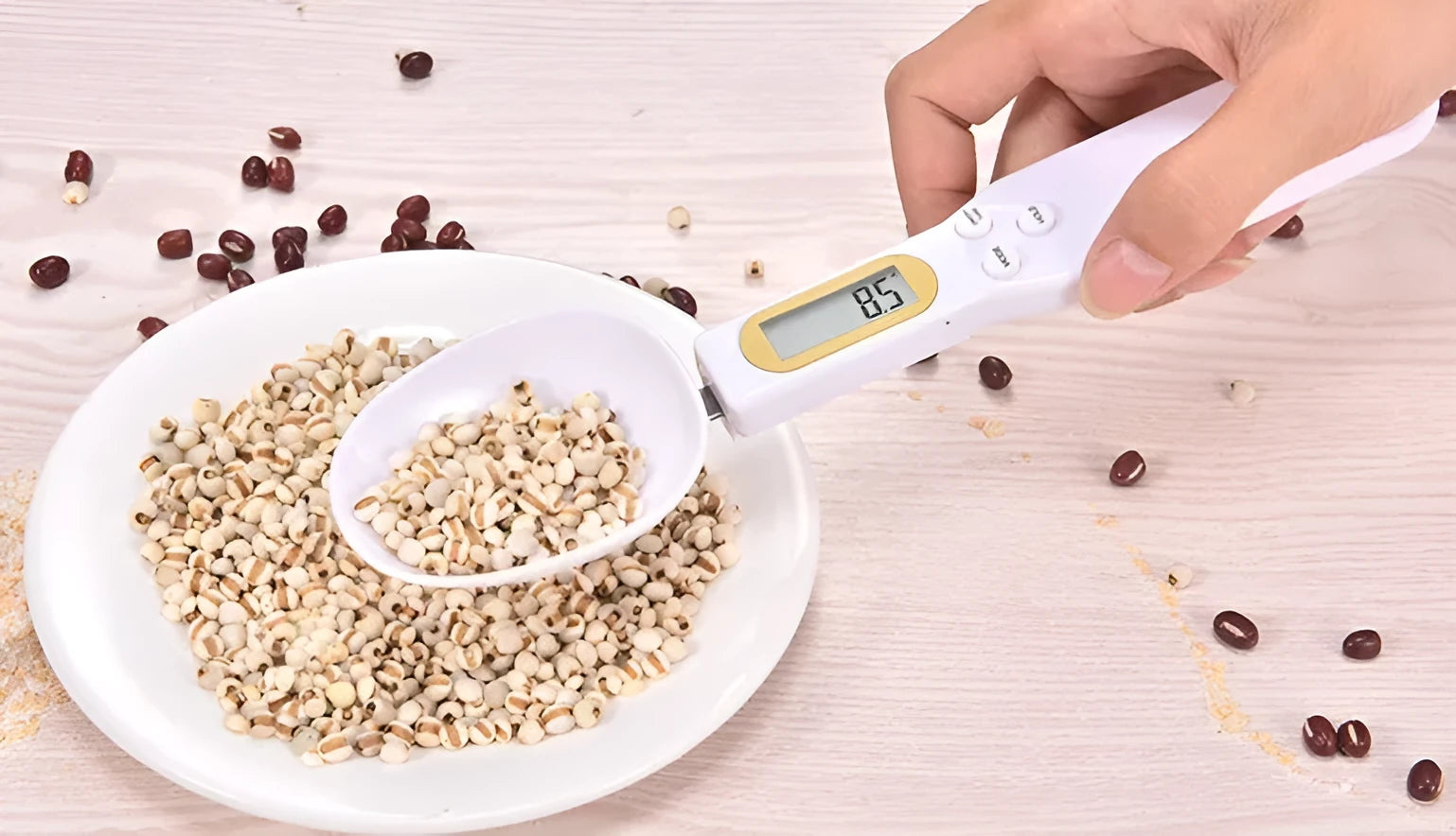 Black electronic digital scale with integrated measuring spoon showing weight display.