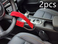 Red iron car steering wheel lock with wire rope for General Motors vehicles on a steering wheel.