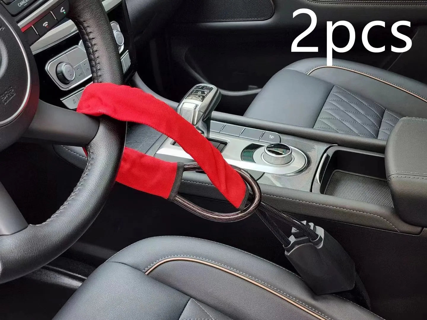 Red iron car steering wheel lock with wire rope for General Motors vehicles on a steering wheel.