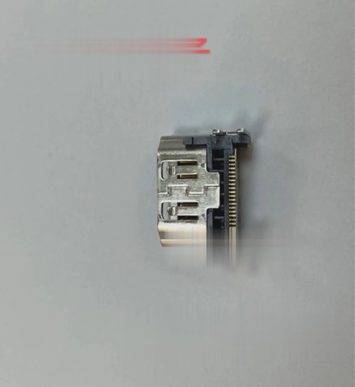 Silver coloured HDMI host socket interface for gaming console accessory.