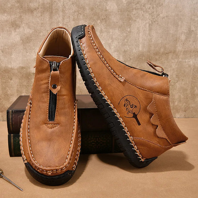 Men's black slip-on leather loafers with round toe and rubber sole, displayed on a white background.