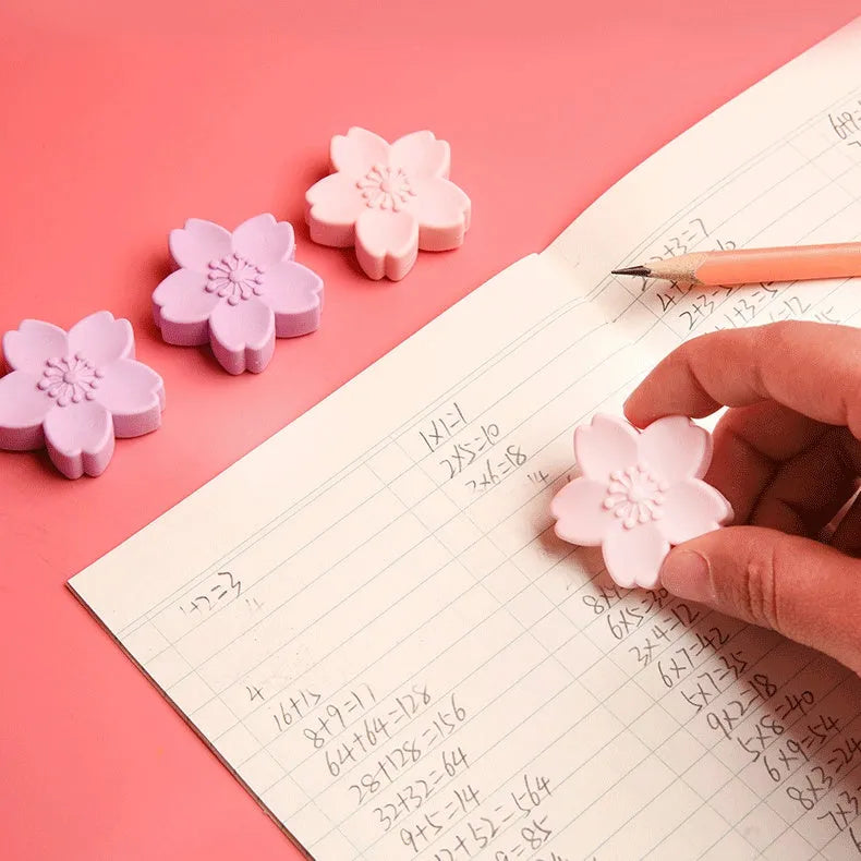 Assortment of cherry blossom decorated erasers in various colours from a bulk pack.