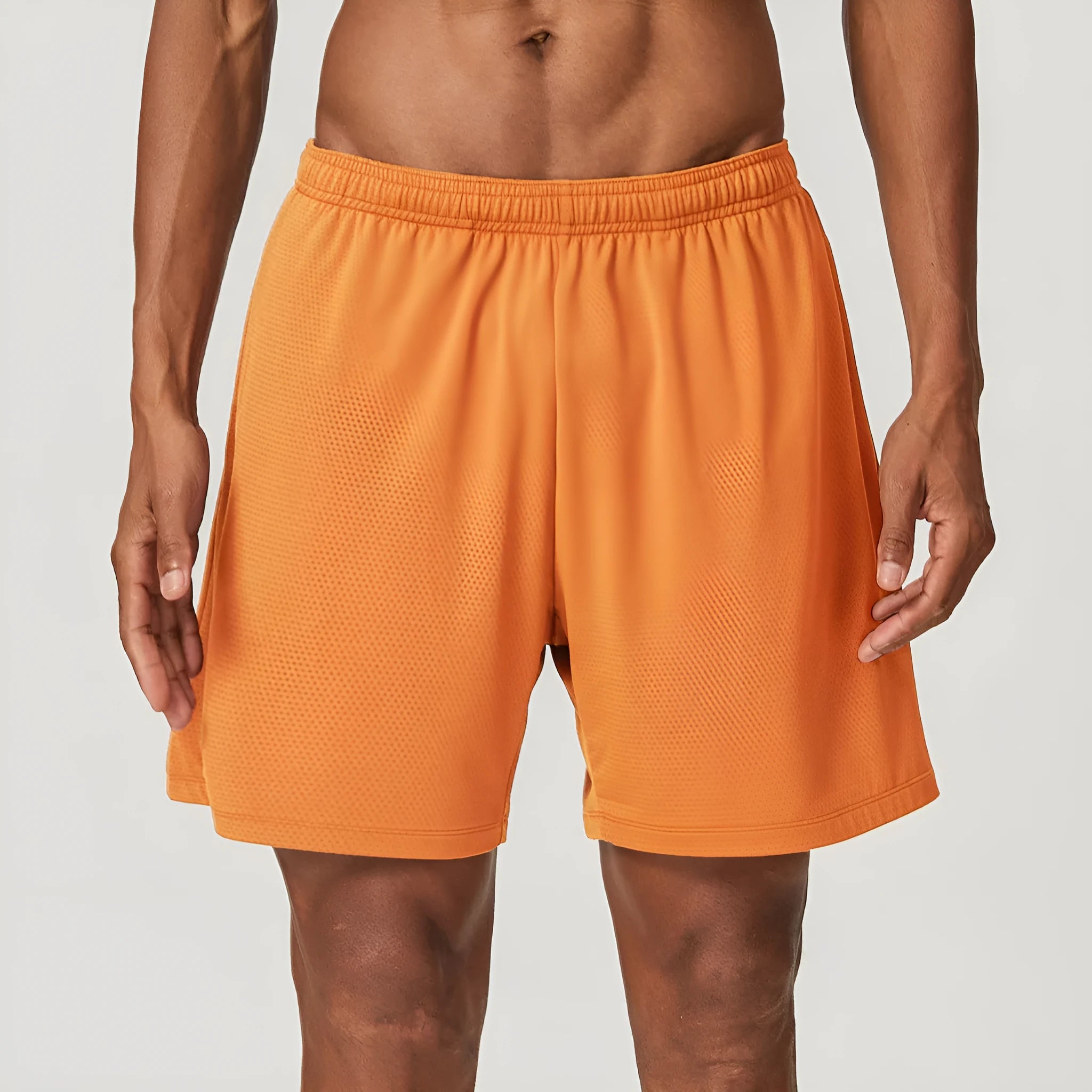 Men's quick-dry double-layer running shorts in a brick red colour on a mid-waist fit model.
