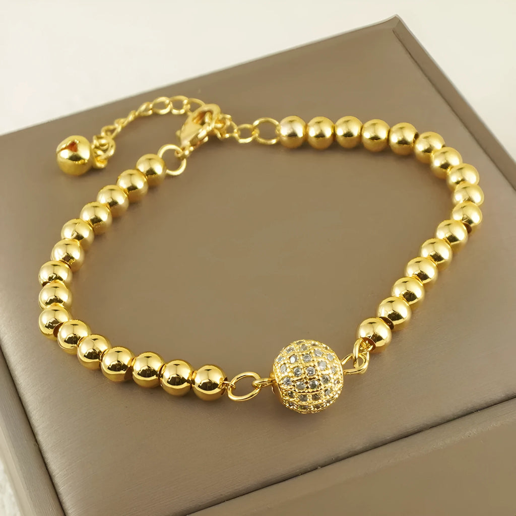 Close-up of a women's copper bracelet with a heart shape design and round zircon stone accents in an Arabic style.