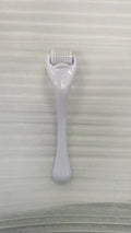 540 micro needle roller tool with black handle and coloured wheel on a white background.