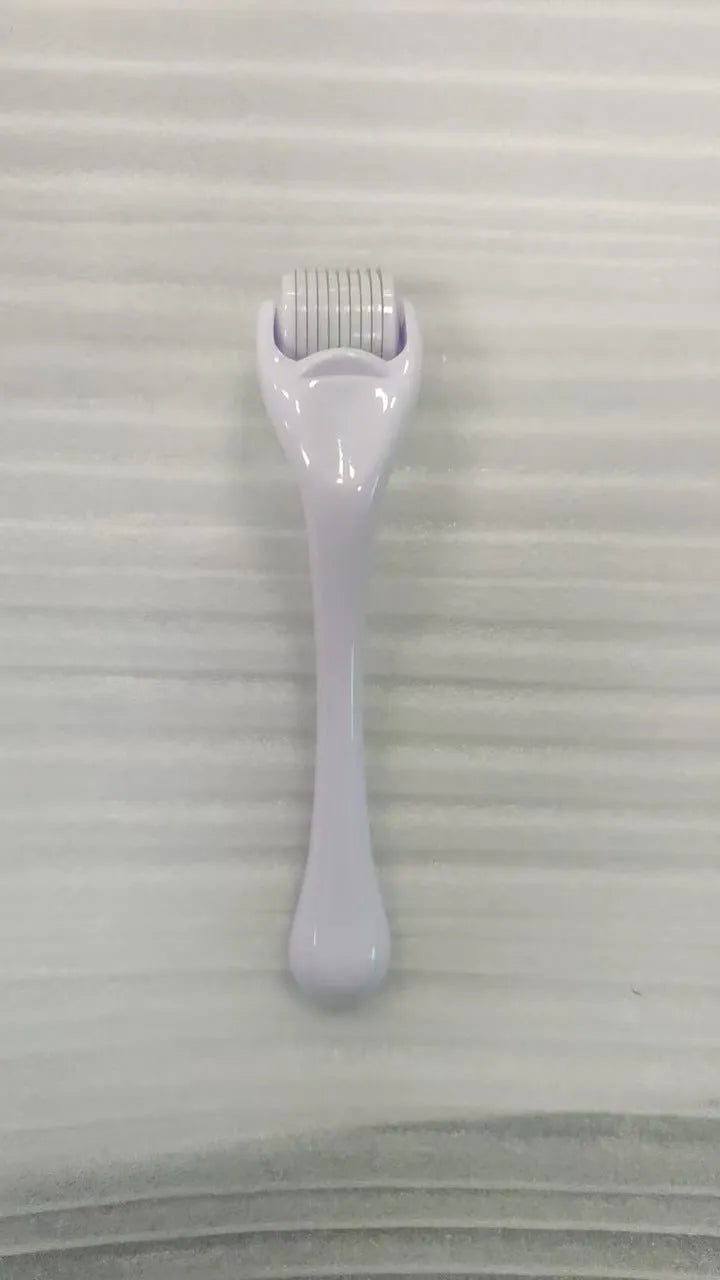 540 micro needle roller tool with black handle and coloured wheel on a white background.