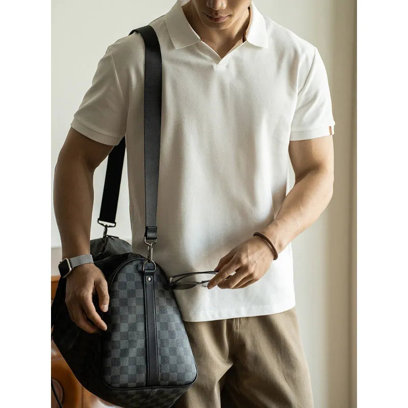 Blue short-sleeved polo shirt on a hanger, showing regular fit and cotton-polyester fabric blend.