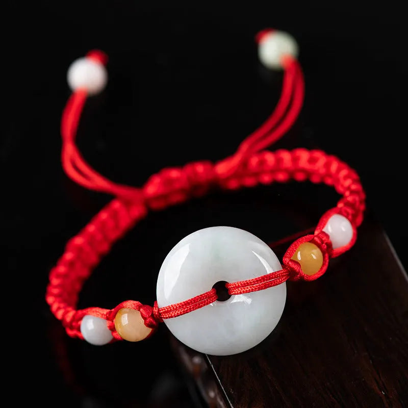 Burmese jade round pendant on an adjustable red rope bracelet with certificate.