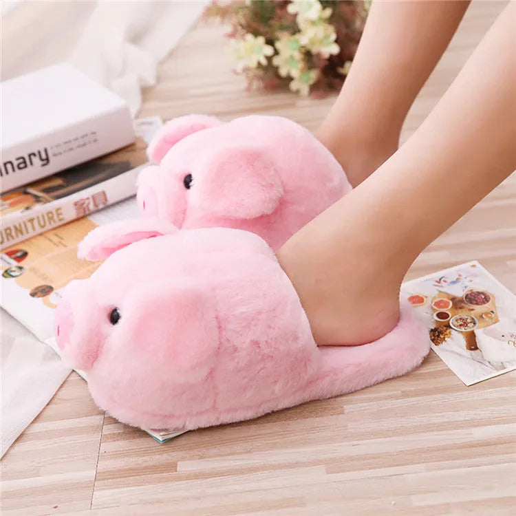 Pink pig-shaped plush floor slippers for indoor use.
