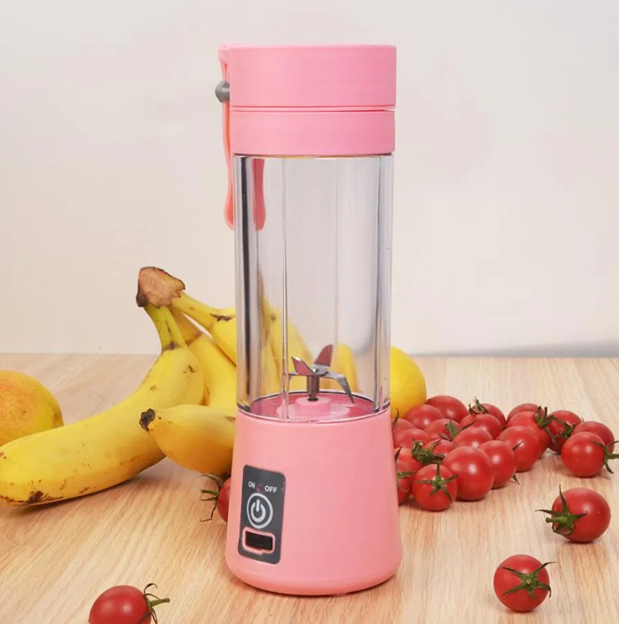 Mini USB-powered centrifugal fruit juicer in pink, with a 400ml plastic cup and stainless steel blade.