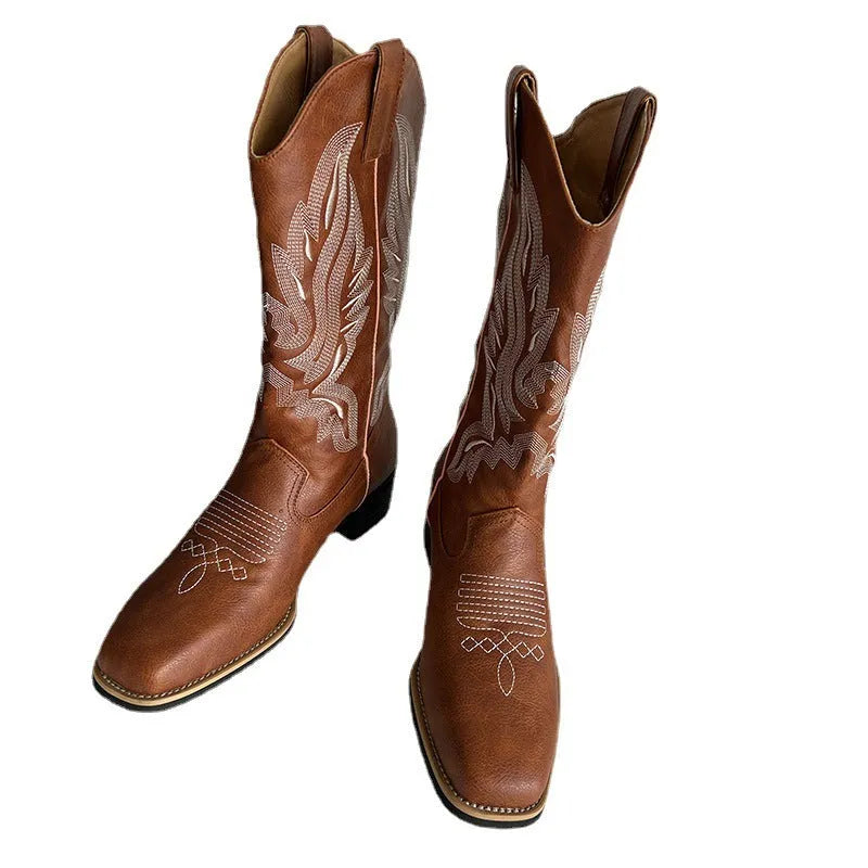 Brown women's mid-calf boots with embroidered pattern, round toe, and low square heel on a rubber sole.