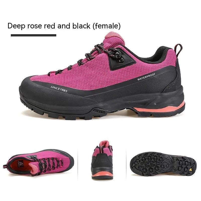 Men's low-top hiking boots in black with leather mesh upper and rubber outsole on a rocky path.