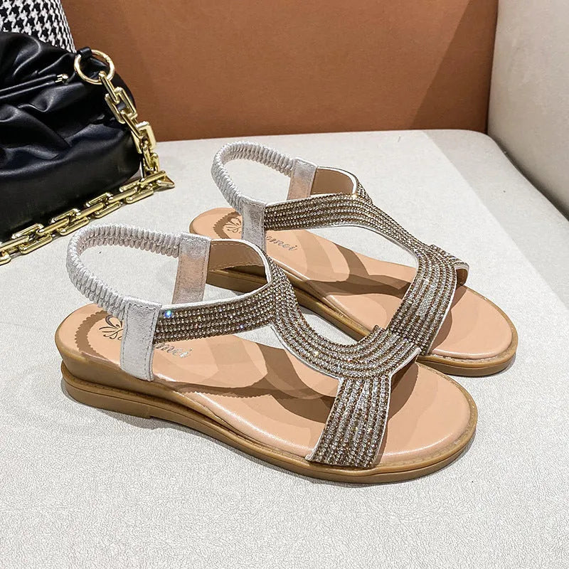 Women's glossy patent leather beach sandals with rhinestone detail on the strap.