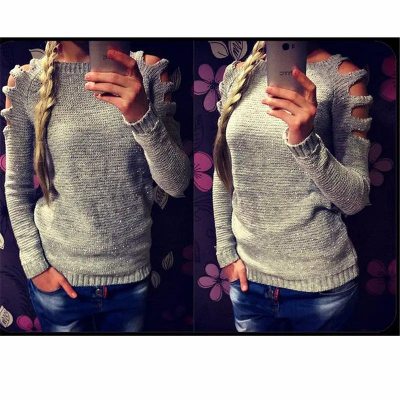 White women's knitted long sleeve shirt with hollow-out crochet detail on a hanger.