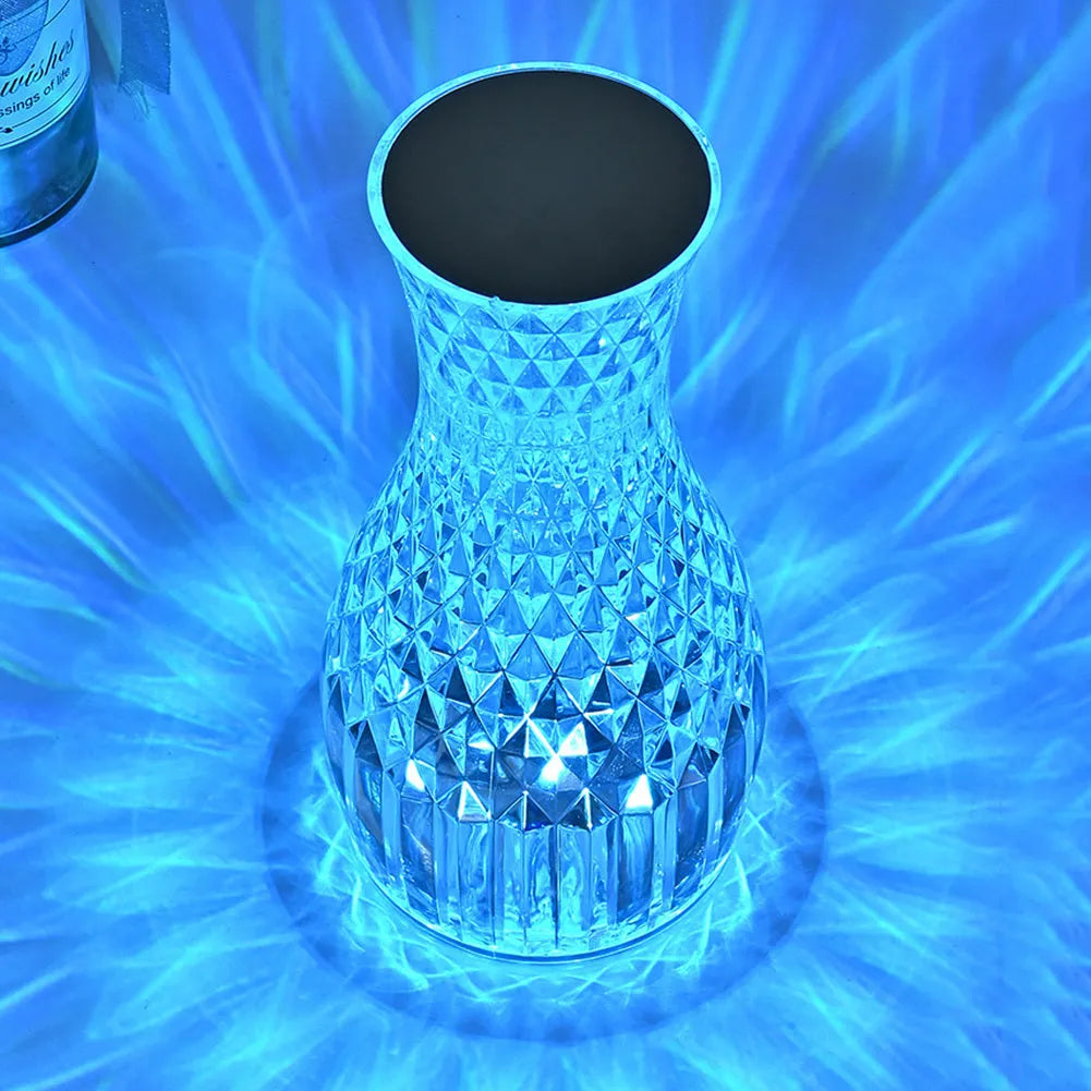Vase-shaped crystal table lamp with diamond-like LED lighting on wooden surface