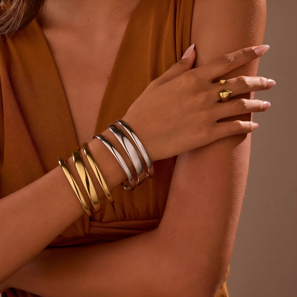Geometric line design stainless steel bracelet with simple opening clasp, shown in gold and steel colour options.